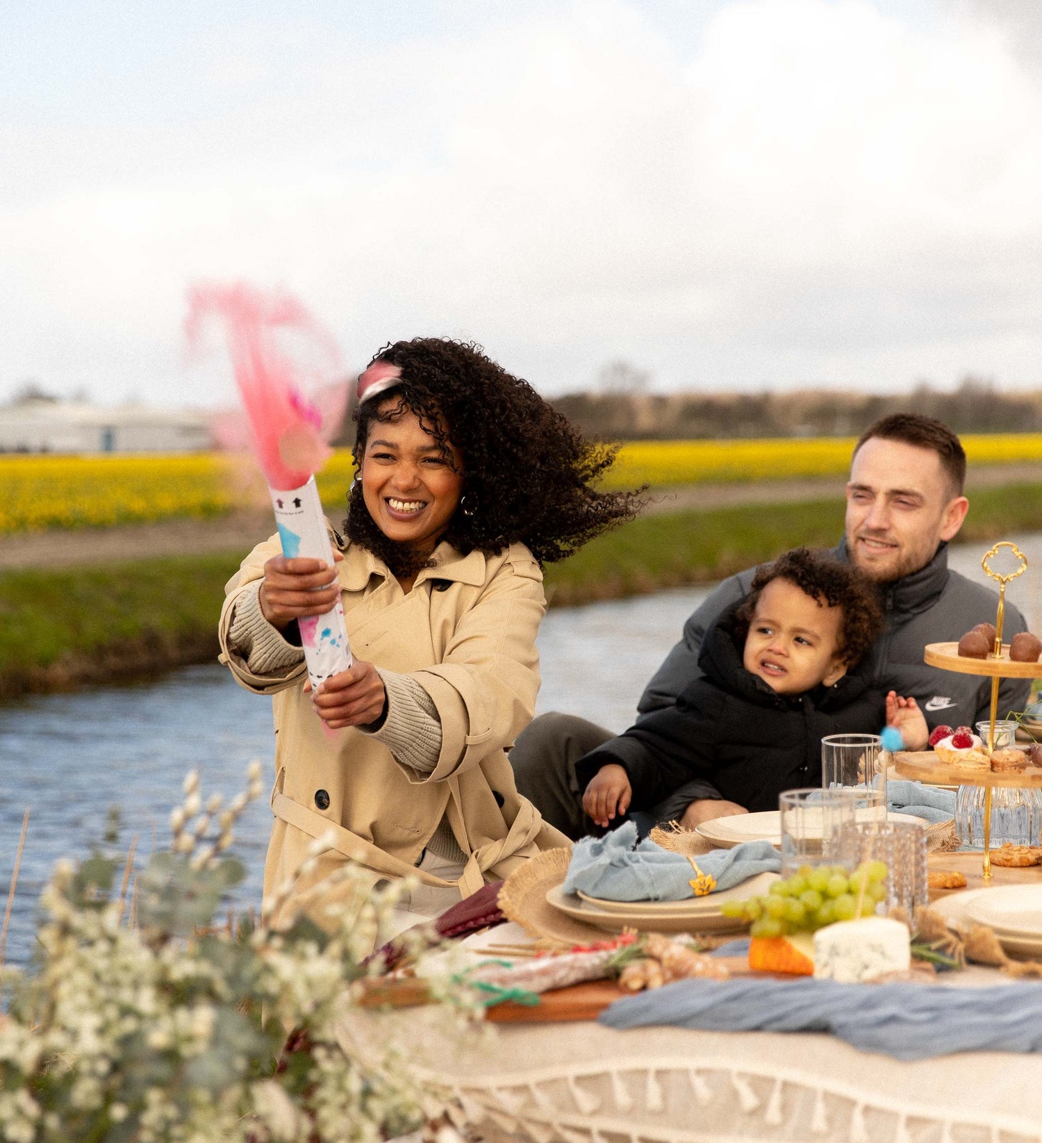 couple pop pink gender reveal girl in flower fields, at luxury picnic
